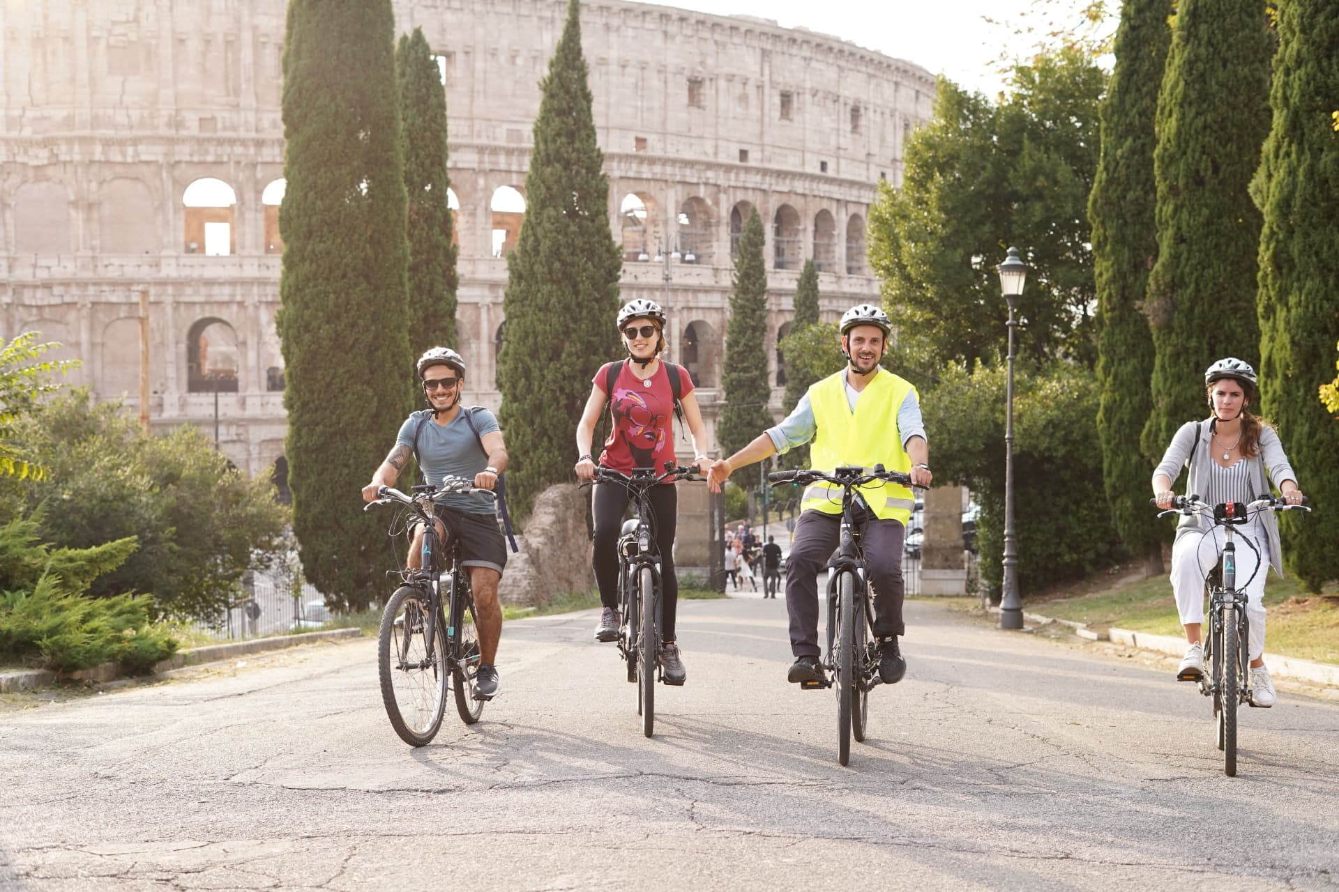 A group cycling past the Colosseum in Rome